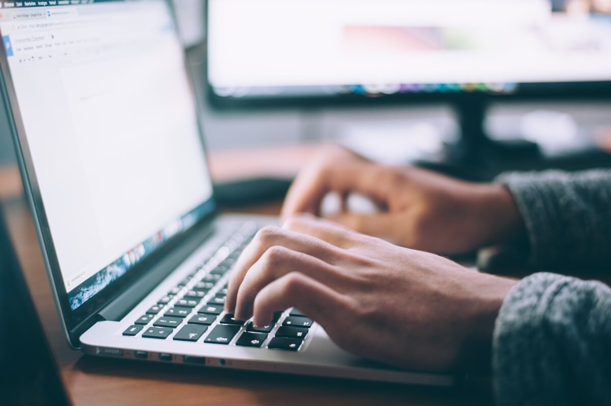Professional working on business email on a laptop